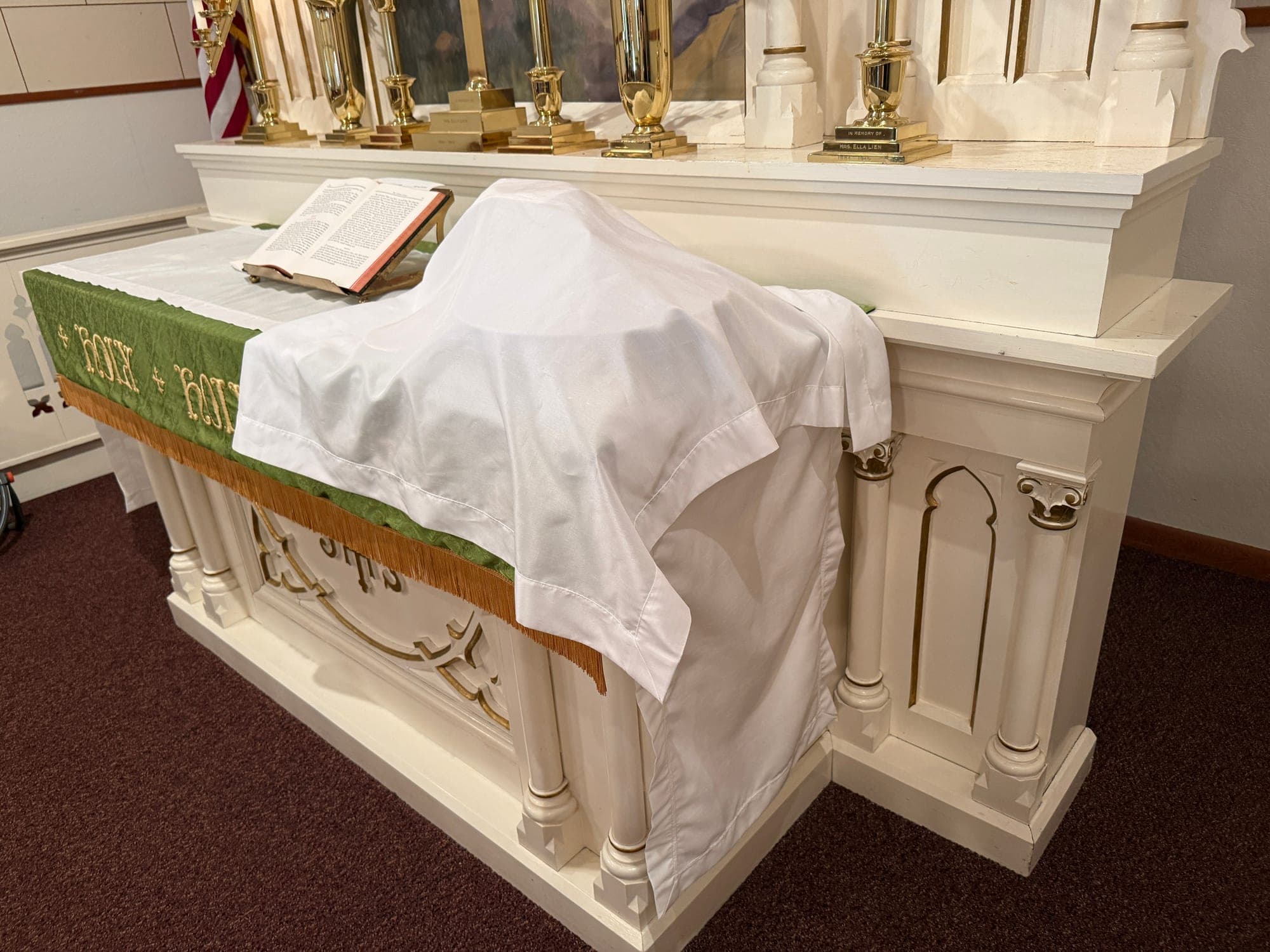 The communion vessels veiled in white linen upon the altar at Calvary Lutheran Church
